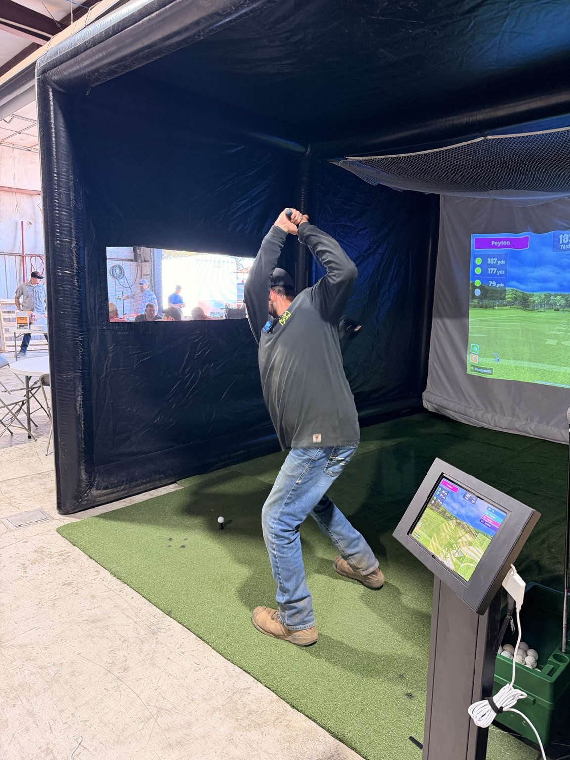 Guest hitting inside the Bedlam Birdies simulator
